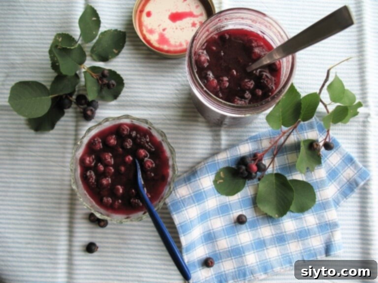 Saskatoon Berries: All Ways Delicious 2 Canned saskatoons and saskatoon berry and peach preserves in jars on a wooden surface