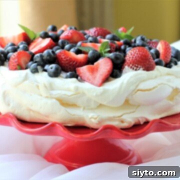Pavlova: A Kiwi Culinary Icon 2 those strawberries and blueberries look like jewels on that pavlova