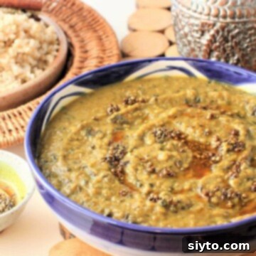 mushroom dal swirled with spiced oil and served with a bowl of brown rice