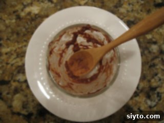 individual serving of chocolate almond tapioca pudding with chocolate curls and slivered almonds