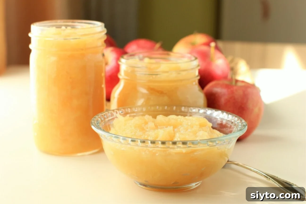 Instant Pot Applesauce No Added Sugar Plus a Kiwi Twist 10 A bowl of Instant Pot applesauce accompanied by two jars filled with the fresh preserve.