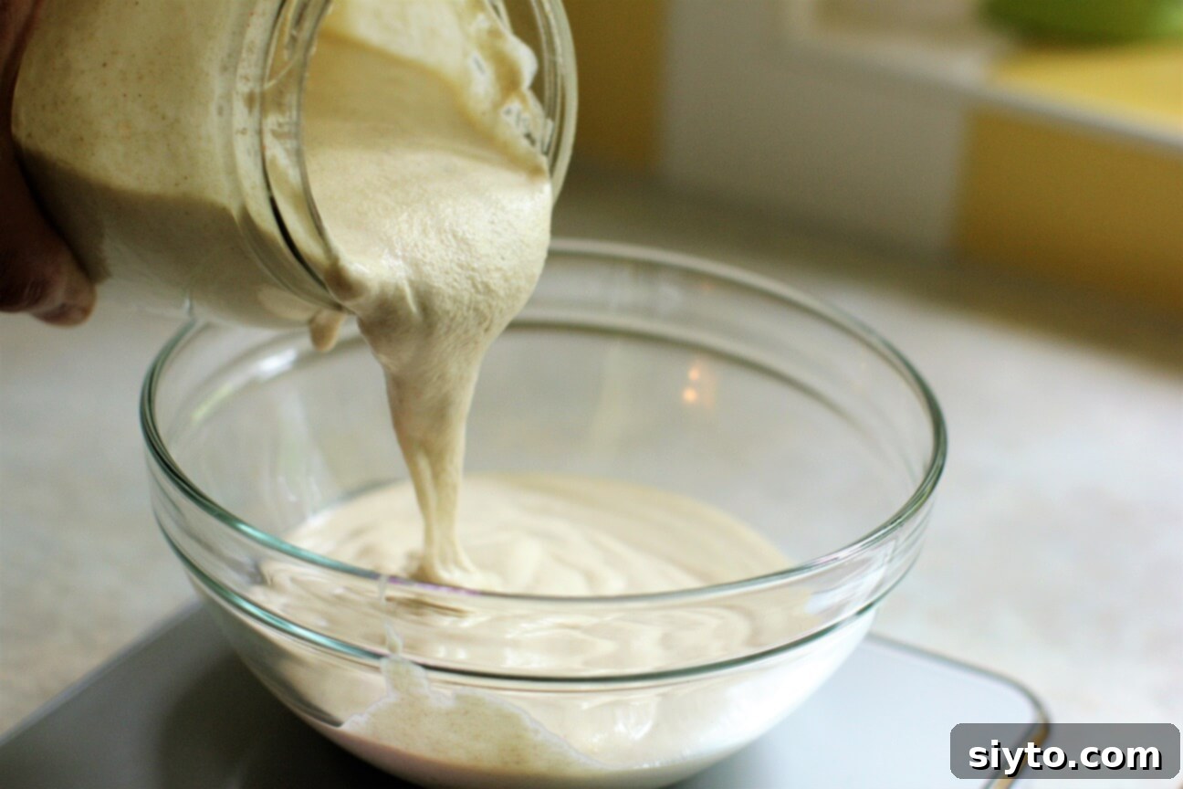 Artisan Gluten Free Sourdough Crackers 5 pouring sourdough discard into bowl for cracker batter
