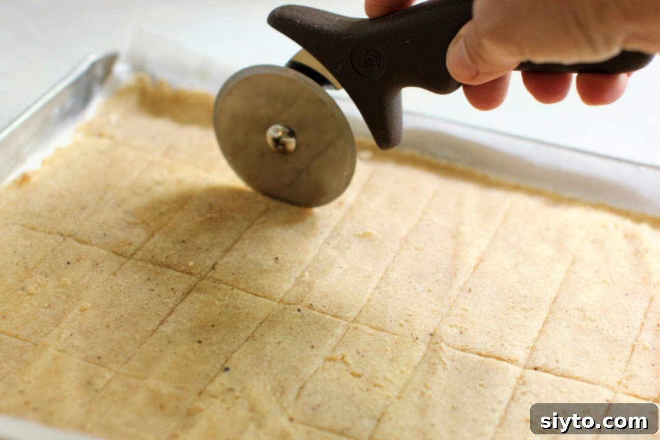 Artisan Gluten Free Sourdough Crackers 8 scoring the sourdough crackers with a pizza cutter for even pieces