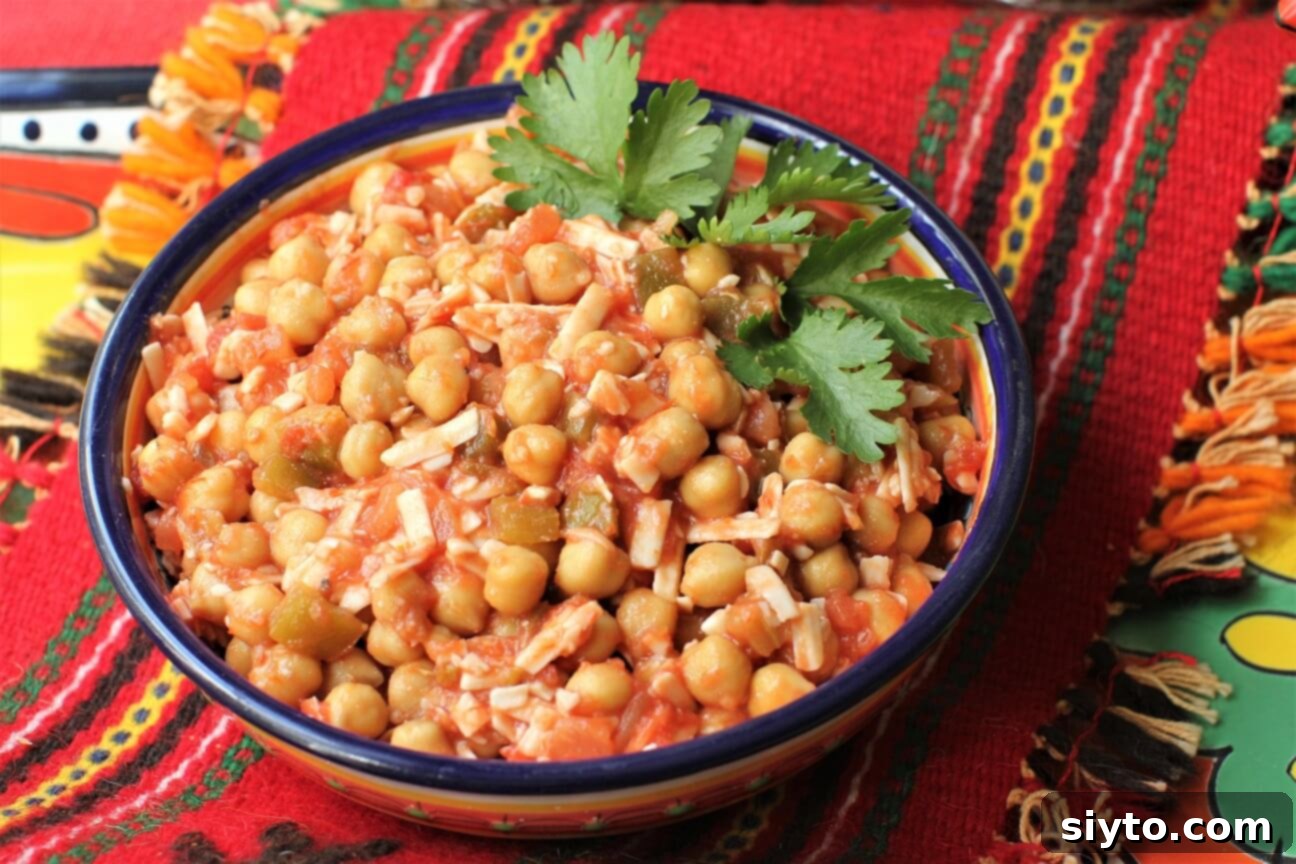 a bowl of southwest chickpea salad and bright red woven runner