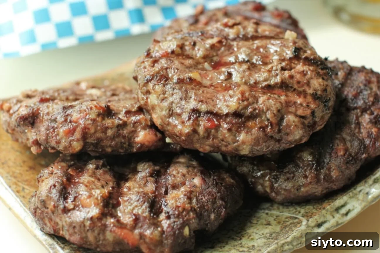 close up of sizzling venison burgers just off the grill