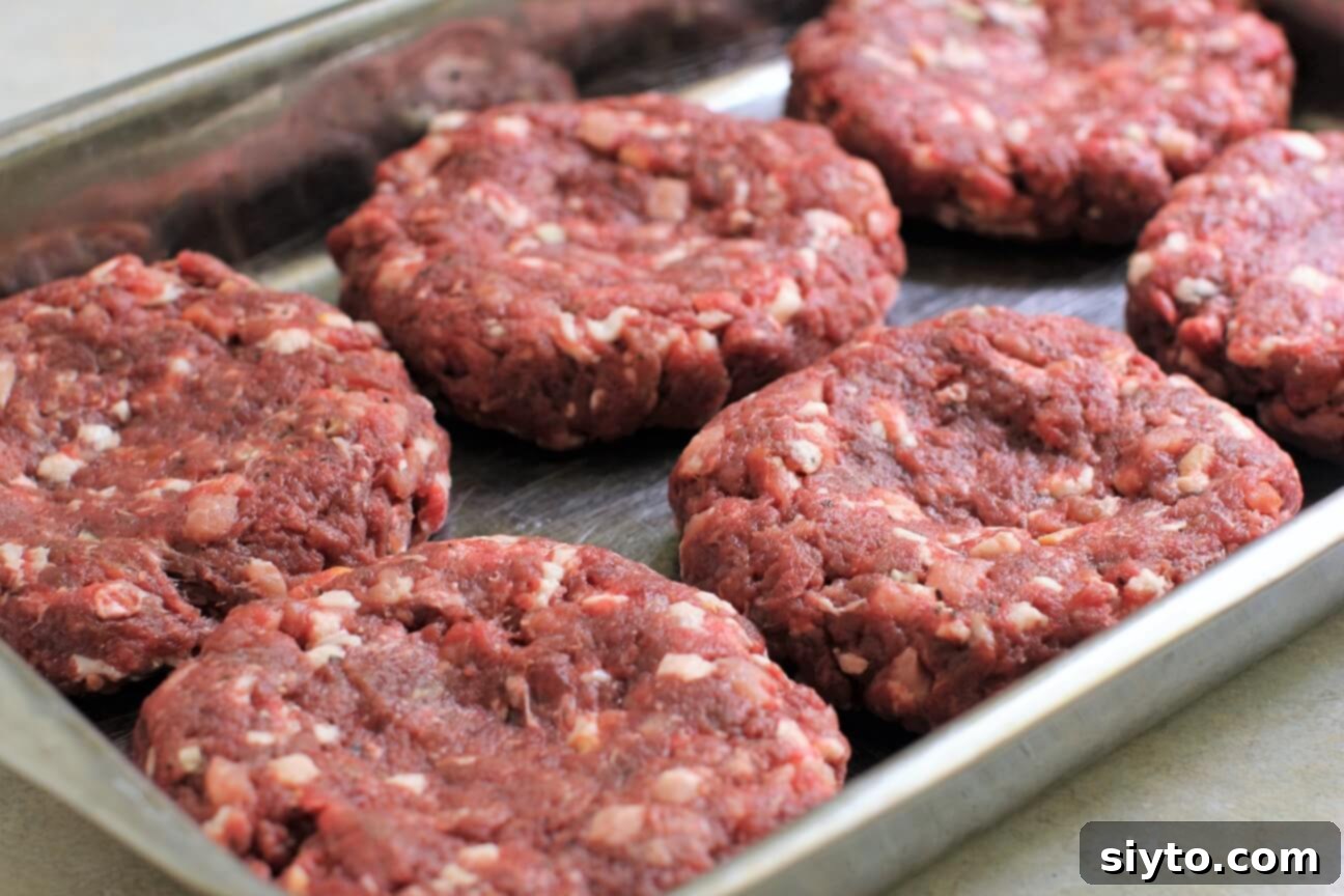 venison burgers with an indent in the middle, ready for the grill