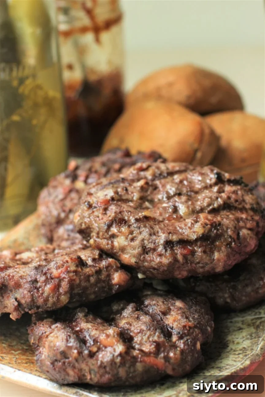 a plate of juicy venison burgers hot off the grill