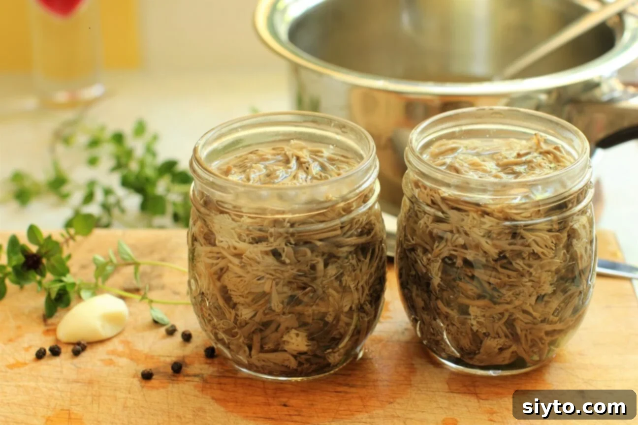 Hands carefully fill small glass canning jars with cleaned and blanched coral mushrooms, preparing them for preservation in a flavorful brine.
