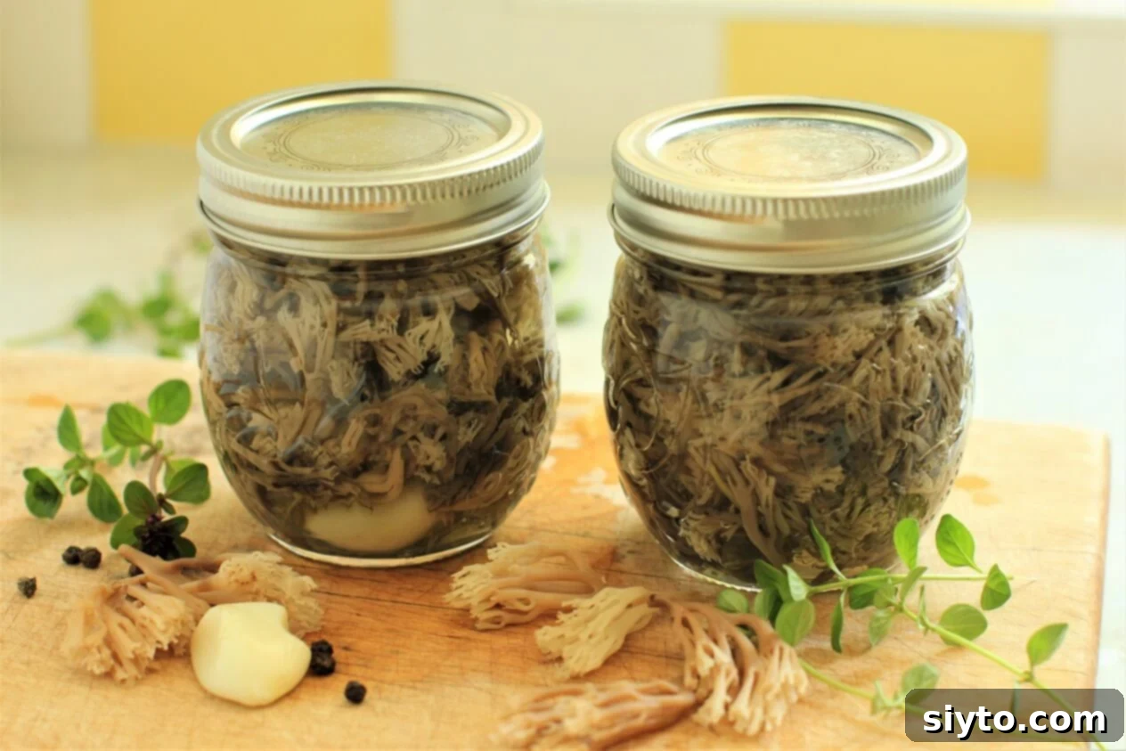 Two neatly labeled jars of preserved coral mushrooms, ready for storage and future use in various recipes, resting on a rustic wooden surface.