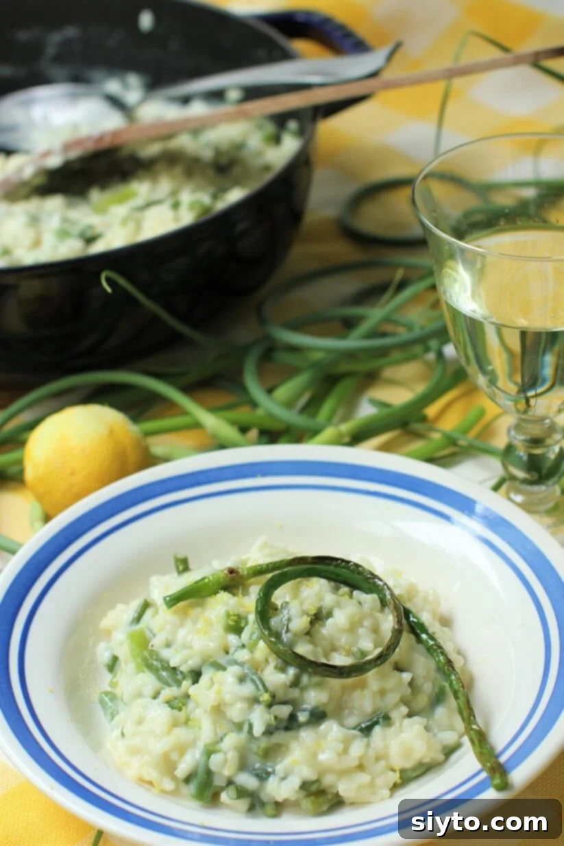 a bowl of garlic scape risotto and a glass of wine