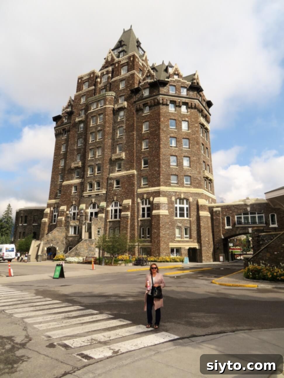 Banff's Best Bites Marinated Flank Steak and Mountain Views 14 Author standing elegantly in front of the grand Banff Springs Hotel, feeling pampered