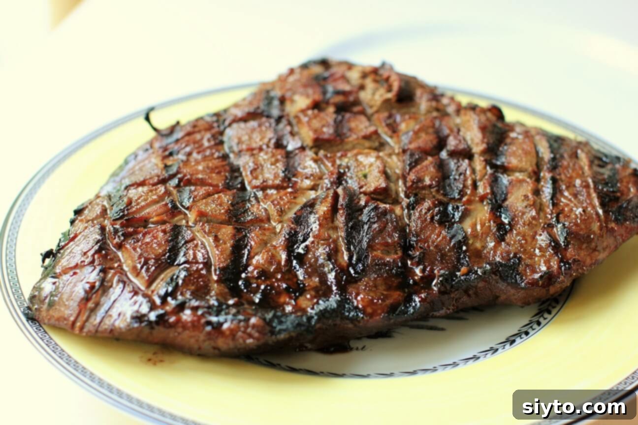Banff's Best Bites Marinated Flank Steak and Mountain Views 7 Beautifully grilled marinated flank steak resting on a wooden cutting board after cooking, before slicing