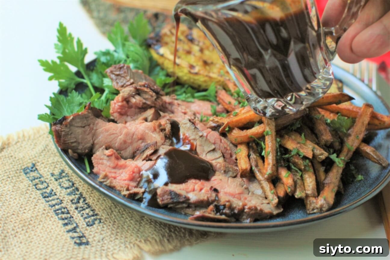 Banff's Best Bites Marinated Flank Steak and Mountain Views 9 Horizontal view of a dinner plate featuring grilled marinated flank steak, crispy fries, and grilled zucchini, highlighting a complete meal