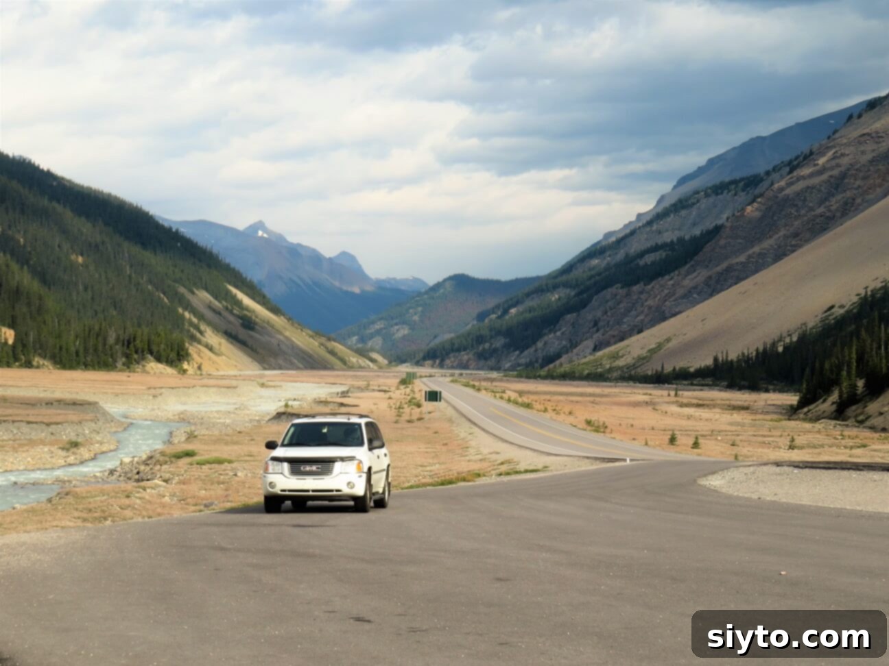 Banff's Best Bites Marinated Flank Steak and Mountain Views 10 Our white SUV parked at a roadside viewpoint on the stunning Icefields Parkway, surrounded by majestic Rocky Mountains