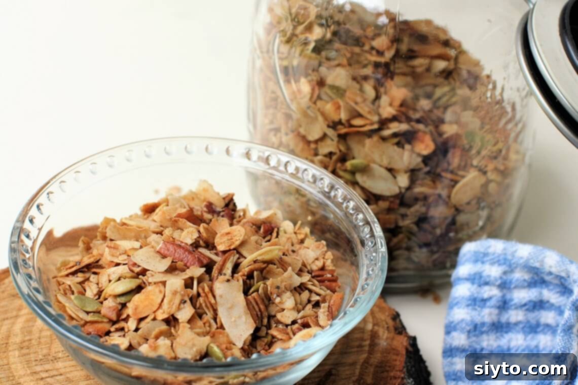 A rustic bowl filled with golden-brown homemade granola, rich with nutty and caramelly tones, awaiting a pour of milk.