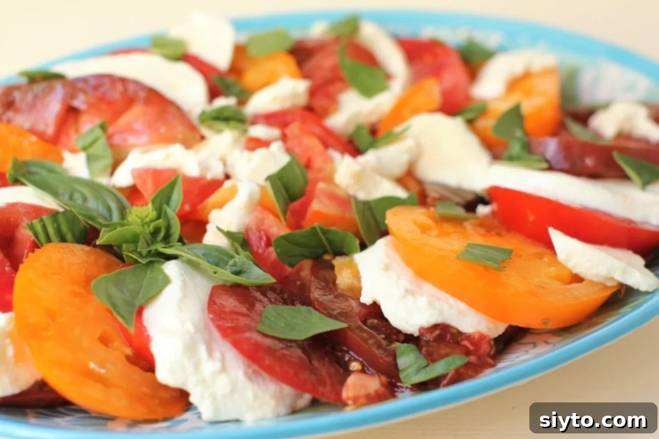 Heirloom Tomato Salad layered on a blue plate