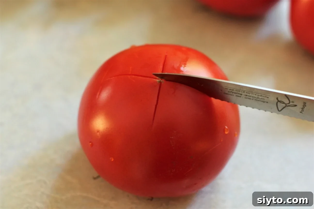 cutting an X into a tomato for blanching and peeling