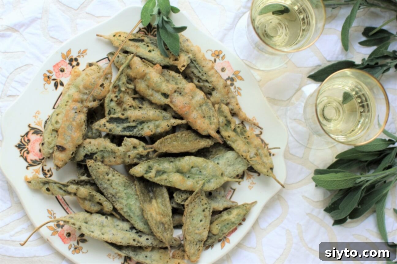 A top-down view of a rustic plate overflowing with golden-brown crispy fried sage leaves, ready to be enjoyed.
