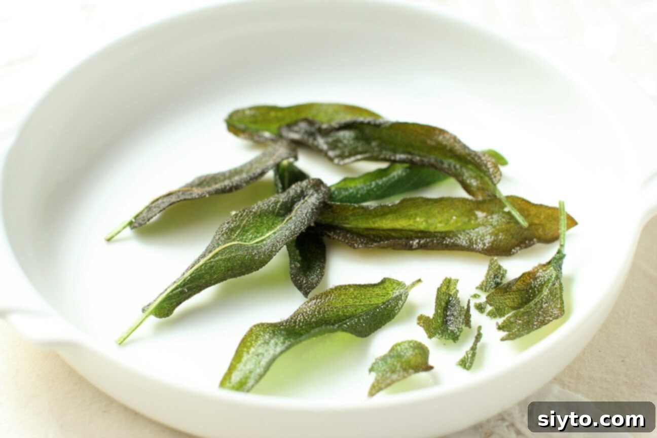 Close-up of crispy fried sage leaves presented simply, ideal for garnishing various dishes.