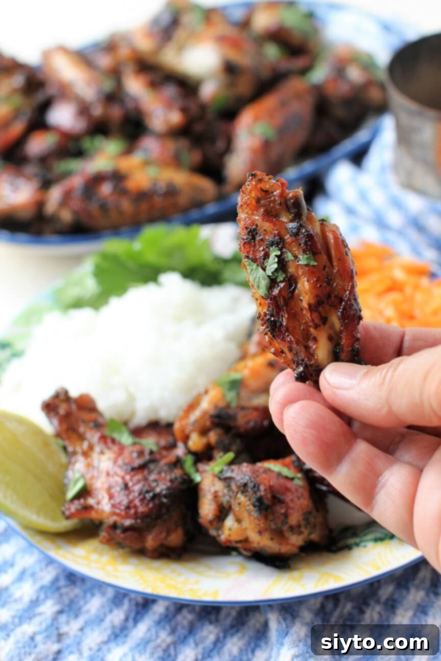 holding up a wing to nibble on