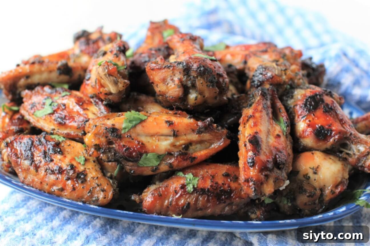 Pile of grilled chicken wings on blue platter