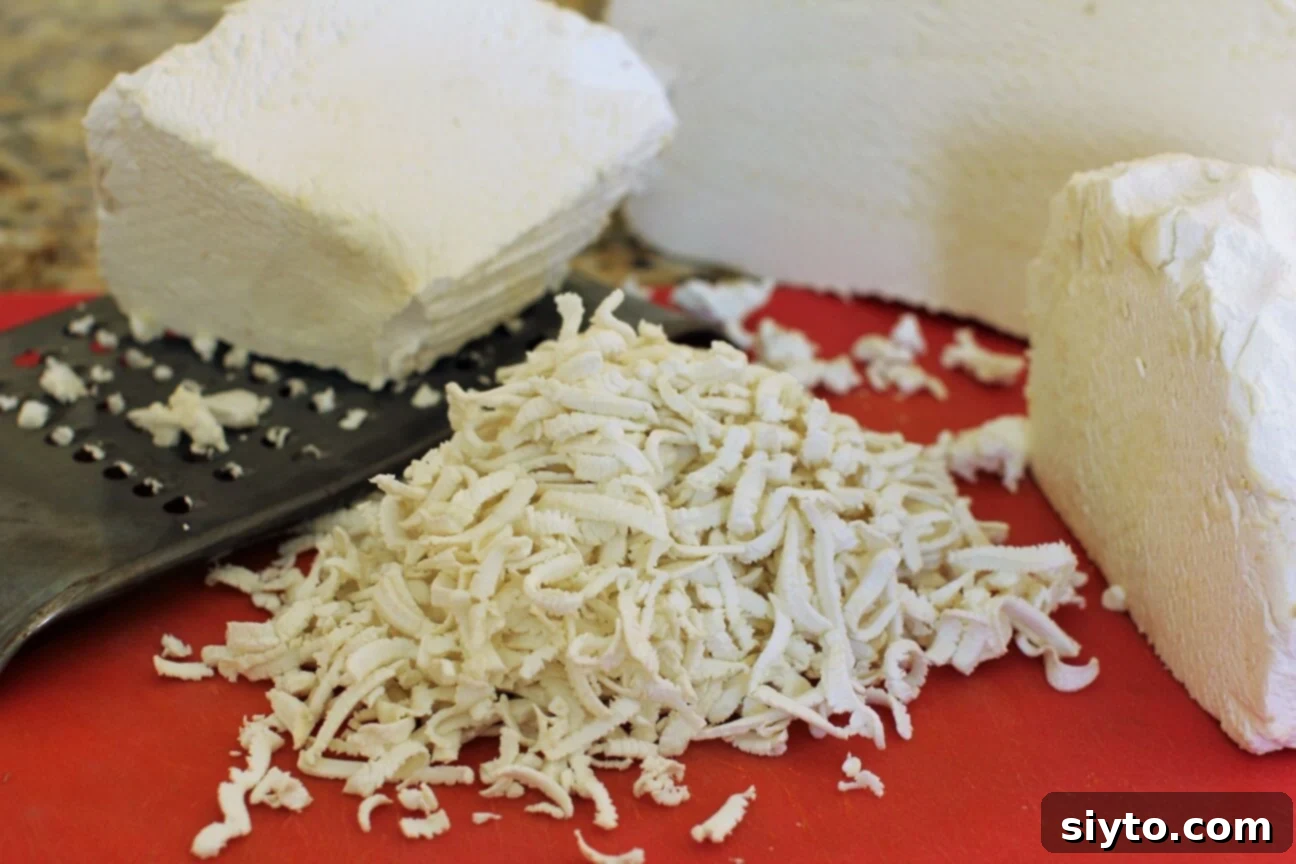 Shredding the pure white giant puffball mushroom using a box grater for the fettuccine recipe
