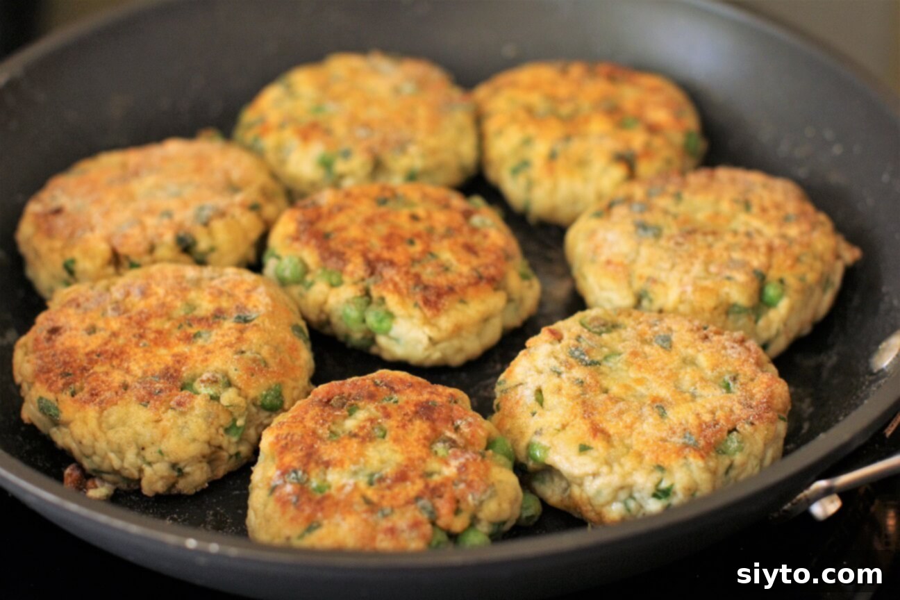 Golden-fried puffball patties sizzling in a skillet, showcasing their perfectly crispy texture.