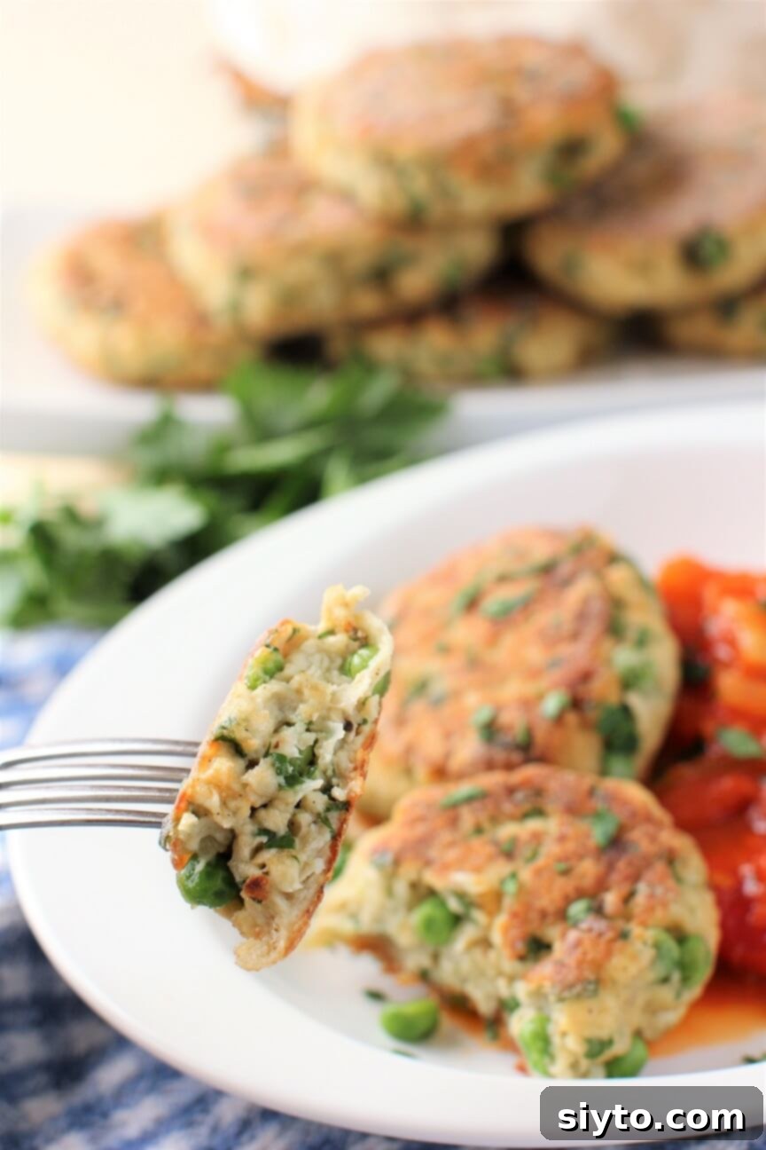 A forkful of puffball patty lifted towards the camera, showing its tender interior and crispy exterior, ready to be eaten.