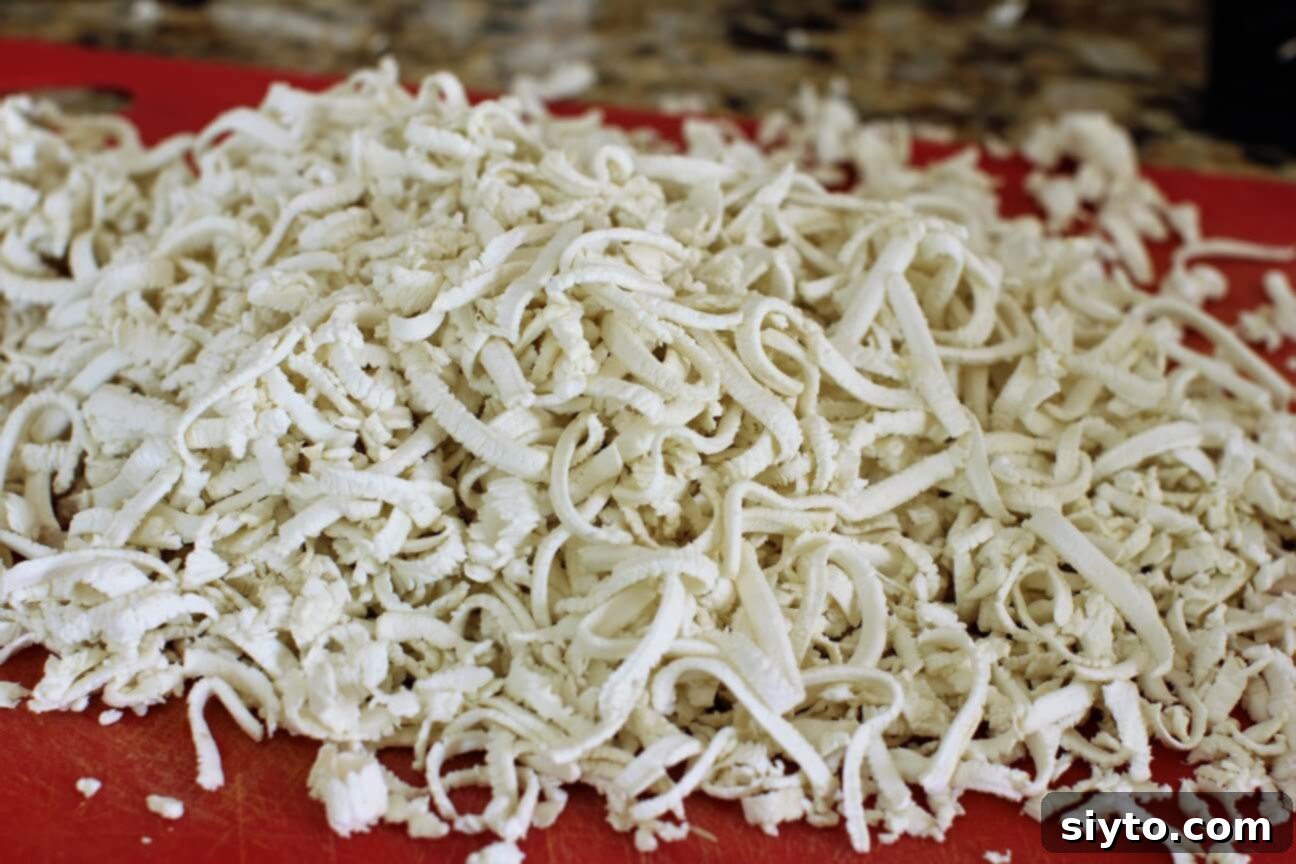 Shredded giant puffball mushroom ready to be used in various recipes, demonstrating its versatile preparation.