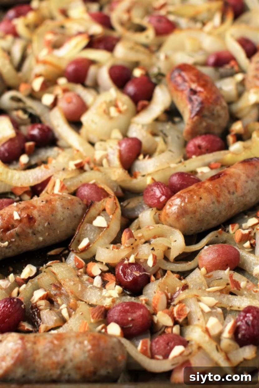 A stunning Bratwurst bake, fresh out of the oven and still in the sheet pan, showcasing its golden, caramelized perfection.