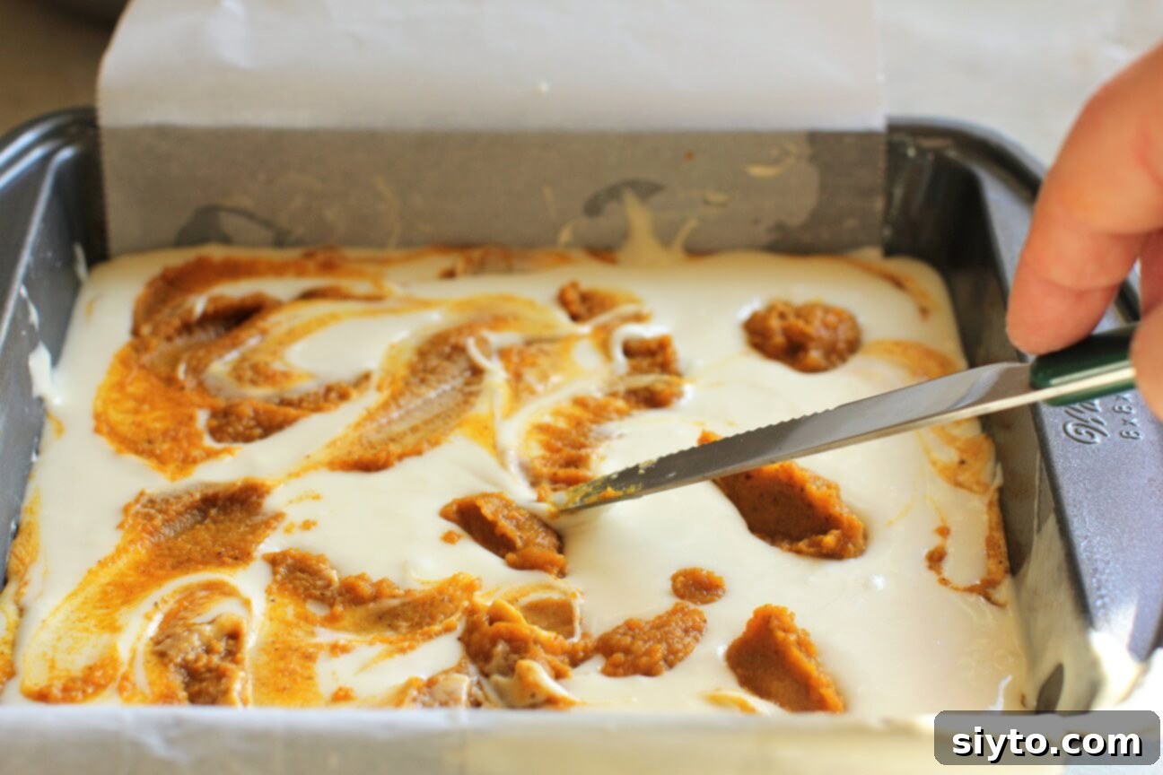 swirling the pumpkin blobs with a butter knife