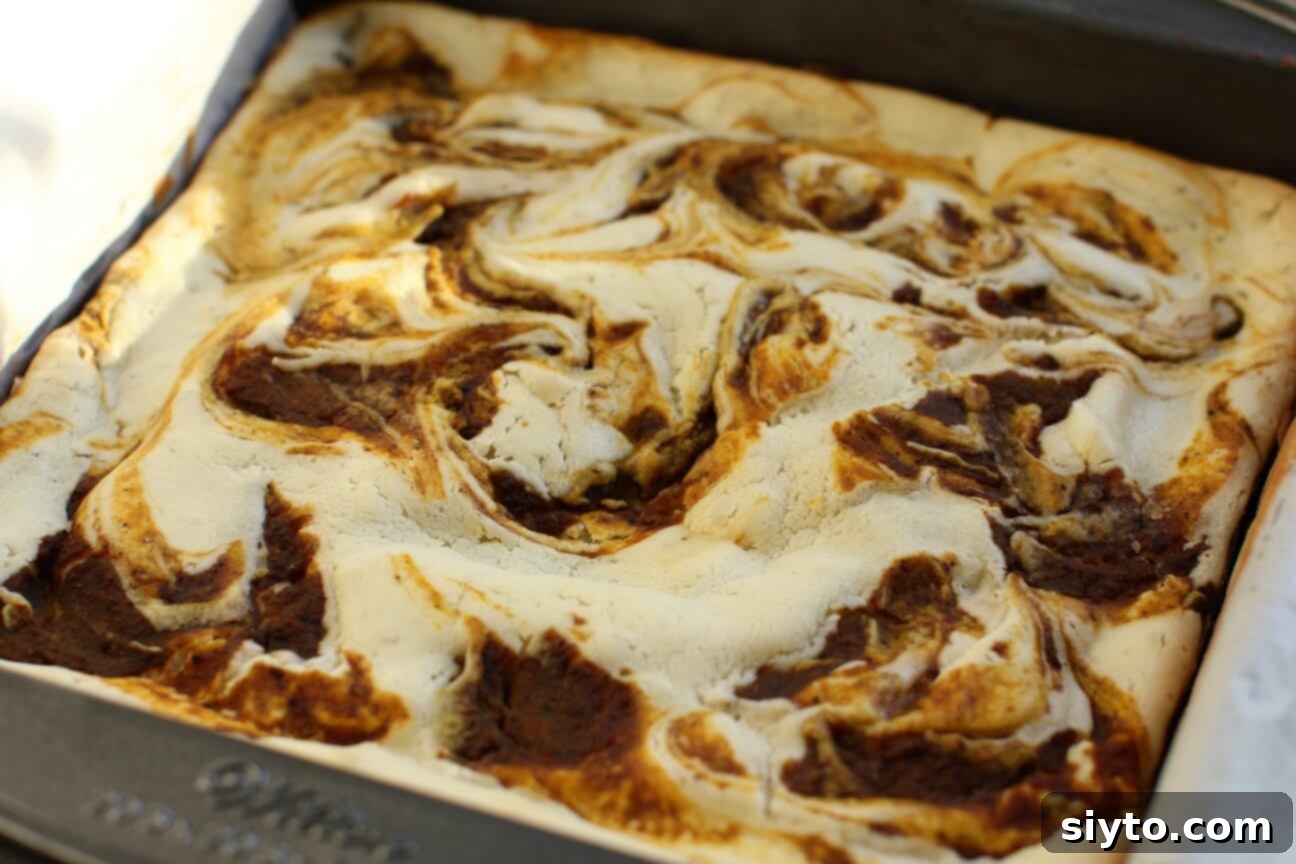 pan of pumpkin mochi bars with swirled top just out of the oven
