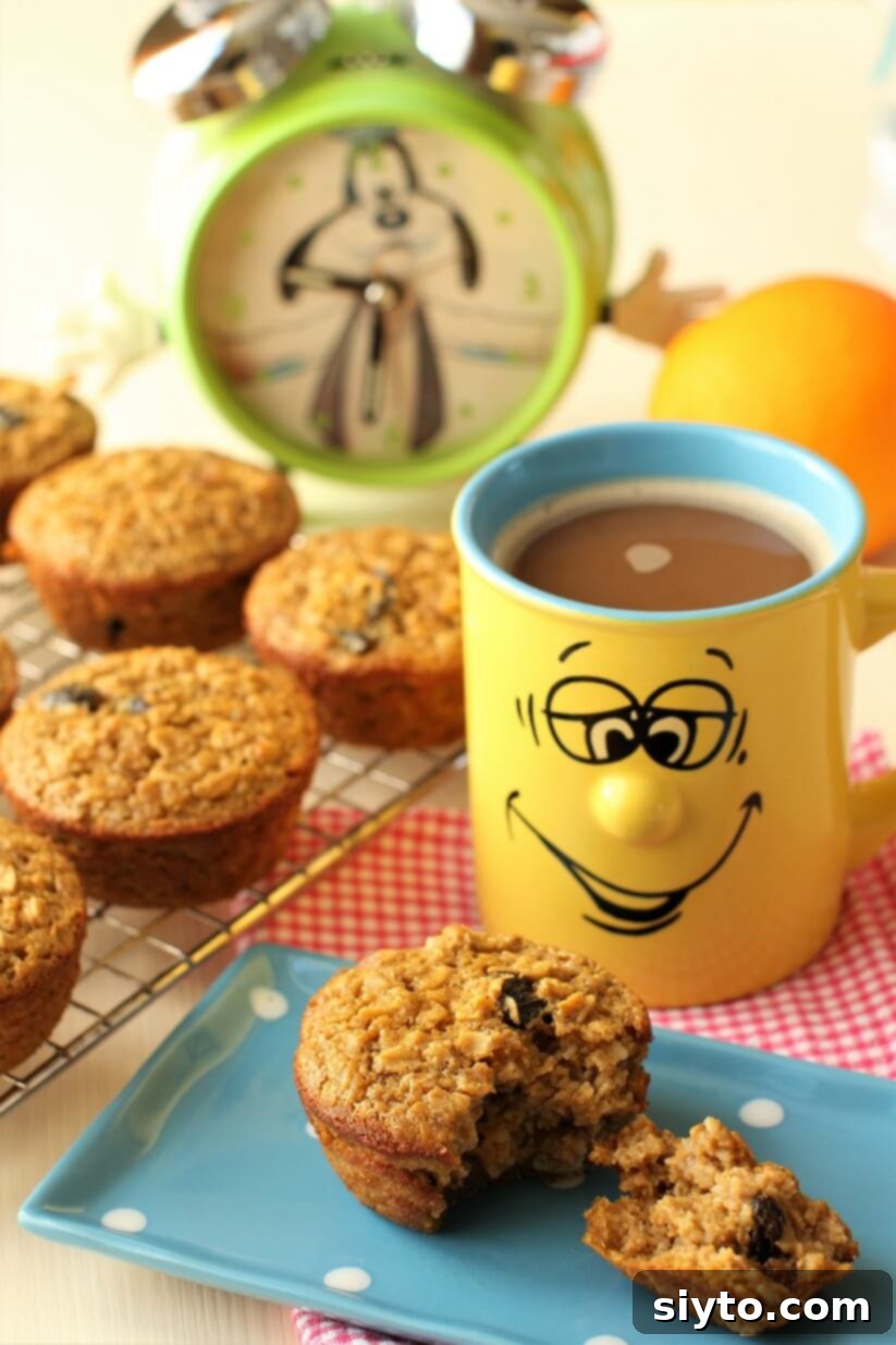 Handheld Harvest Pumpkin Oatmeal Muffins 2 baked oatmeal muffin on a blue polka-dot plate with happy face mug