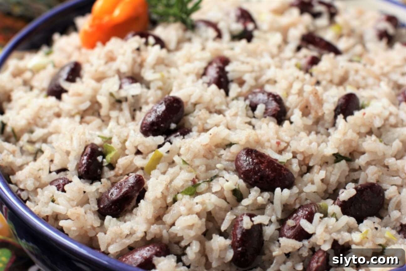 Close-up shot of a serving of Jamaican Rice and Peas, highlighting the vibrant colors and appealing texture of the dish.