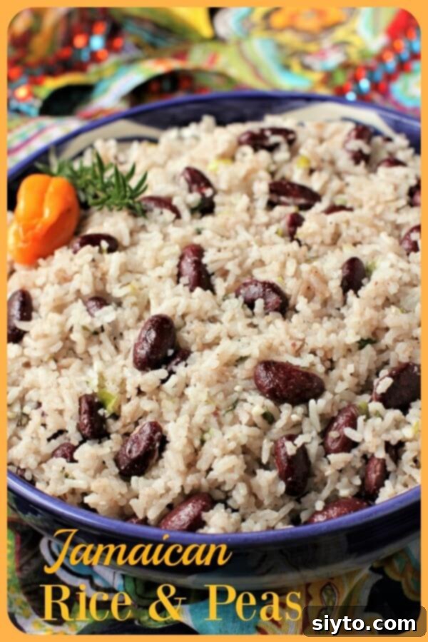 Beautiful blue ceramic bowl filled with freshly made Jamaican Rice and Peas, garnished with a sprig of thyme. Styled for a captivating food photograph.