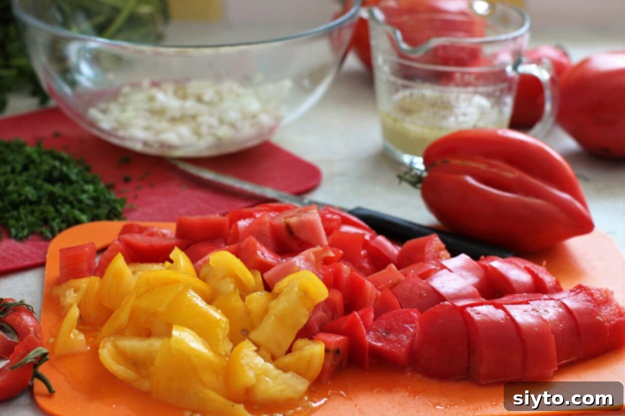 Classic German Tomato Salad 3 Ingredients for a German Tomato Salad laid out, including various tomato types and fresh herbs