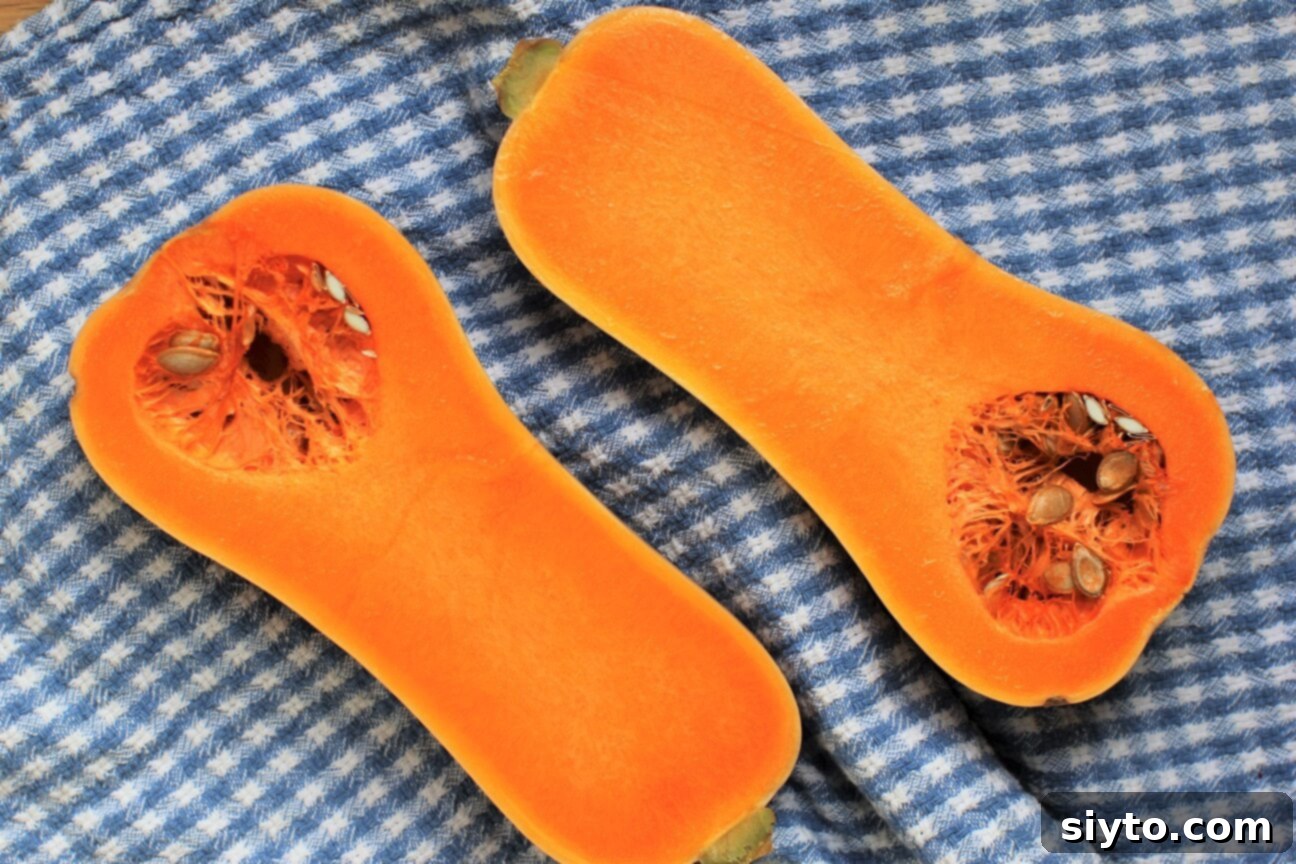 two halves of butternut squash on blue checked towel