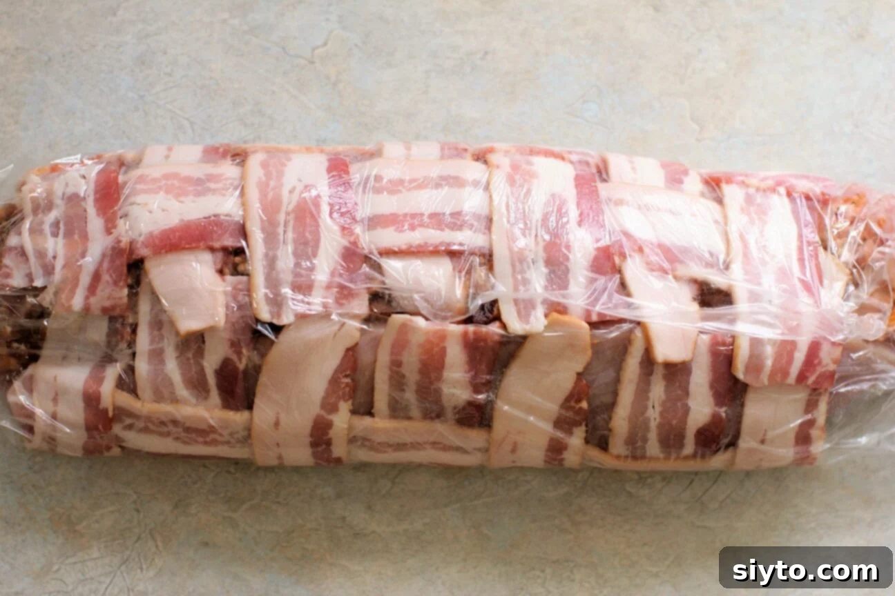 Savory Bacon Wrapped Stuffed Turkey Breast 12 bring up both sides of the bacon mat around the turkey roll