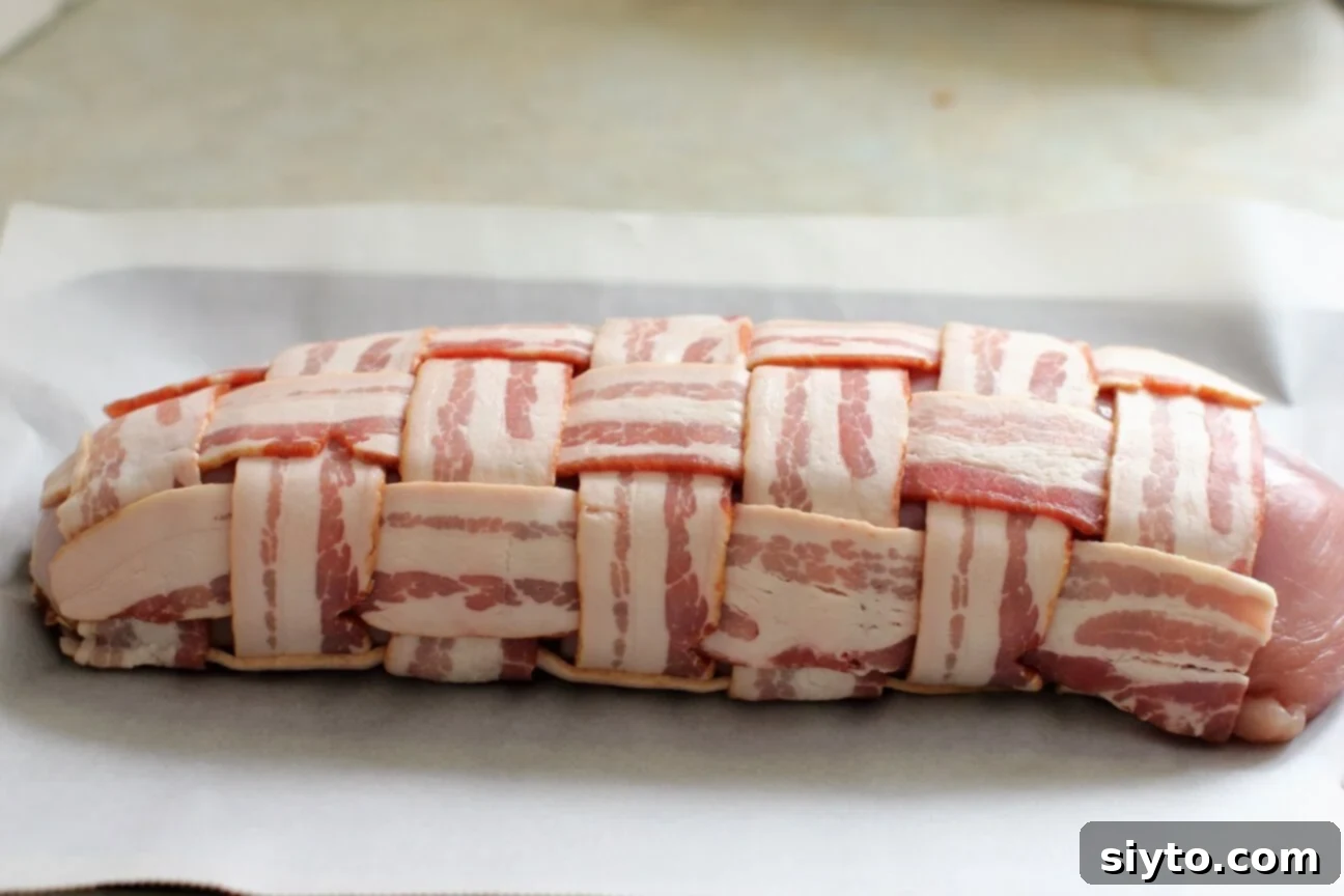 Savory Bacon Wrapped Stuffed Turkey Breast 13 rolled, wrapped turkey breast on the baking sheet