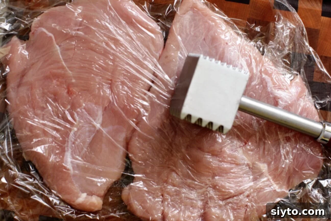 Savory Bacon Wrapped Stuffed Turkey Breast 4 pound with a meat mallet