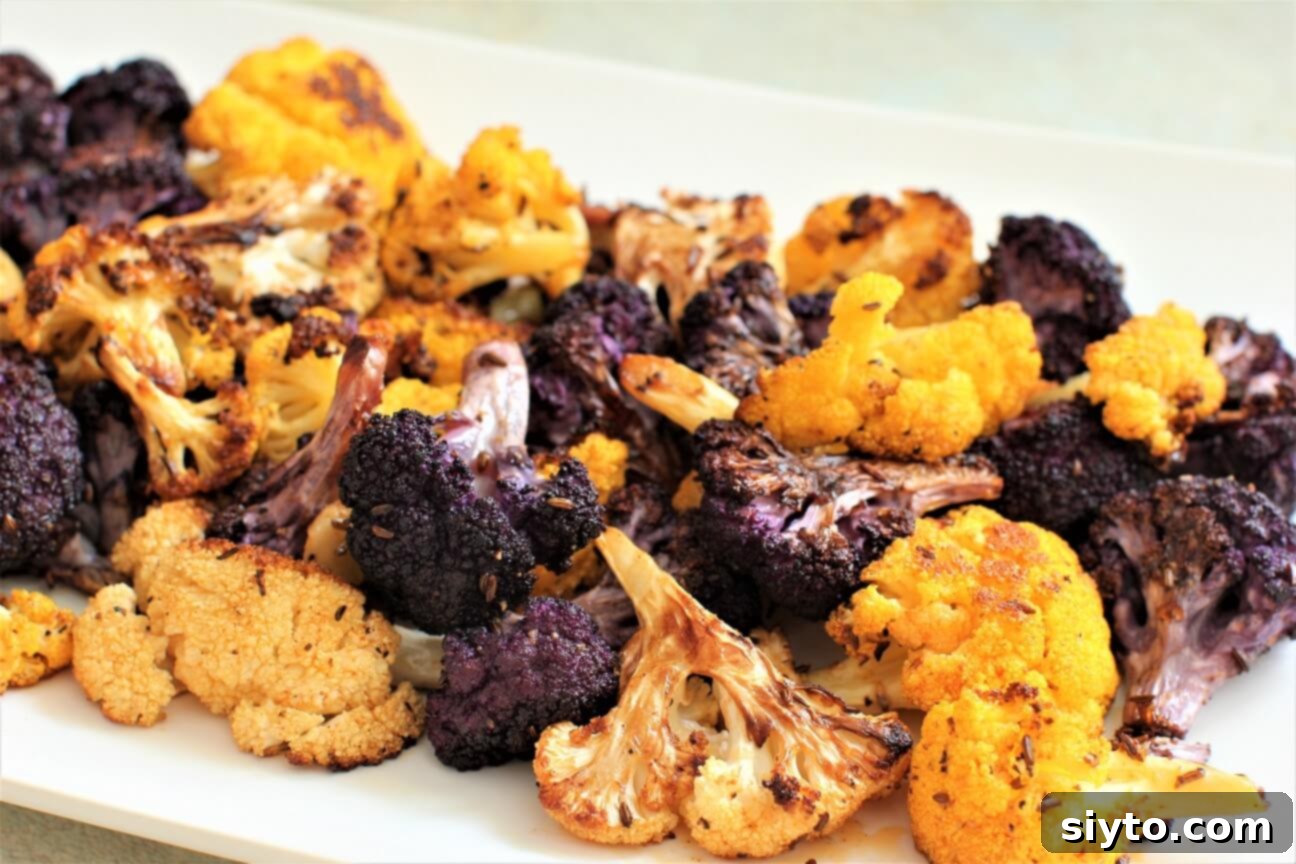 A vibrant plate featuring multi-colored roasted cauliflower florets, highlighting the diverse natural hues of the vegetable.