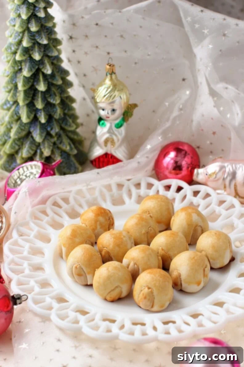 a festive plate of Bethmännchen Marzipan Cookies, with Christmas ornaments around it
