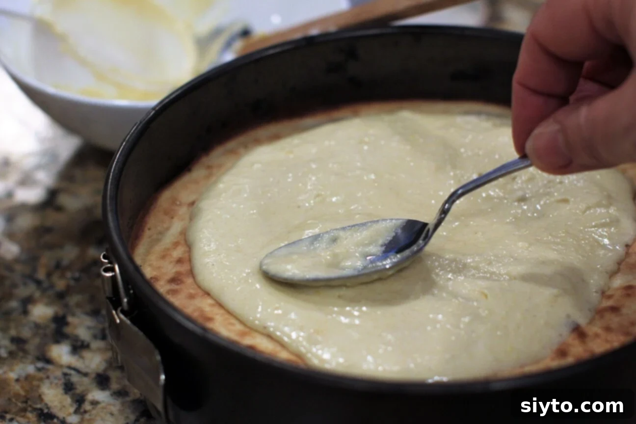spreading a layer of batter to be grilled