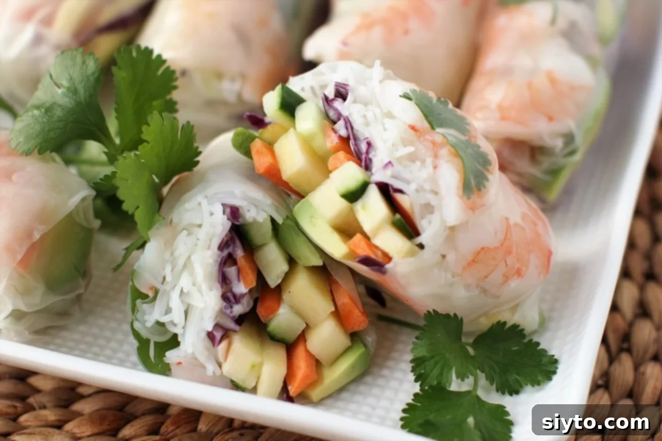 A close-up view of the fresh, colorful filling meticulously arranged within a translucent rice paper wrapper, before being fully rolled.