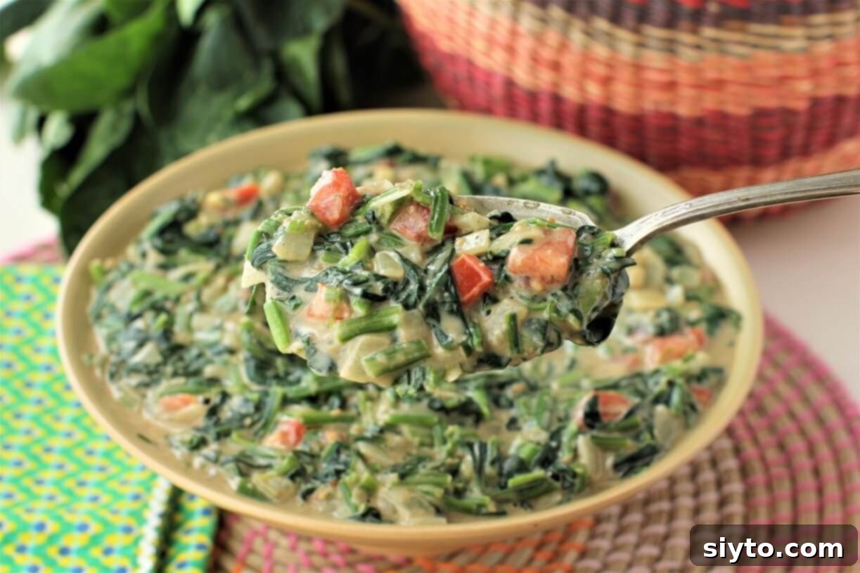 luscious spoonful of peanut creamed spinach, showing its rich, creamy texture
