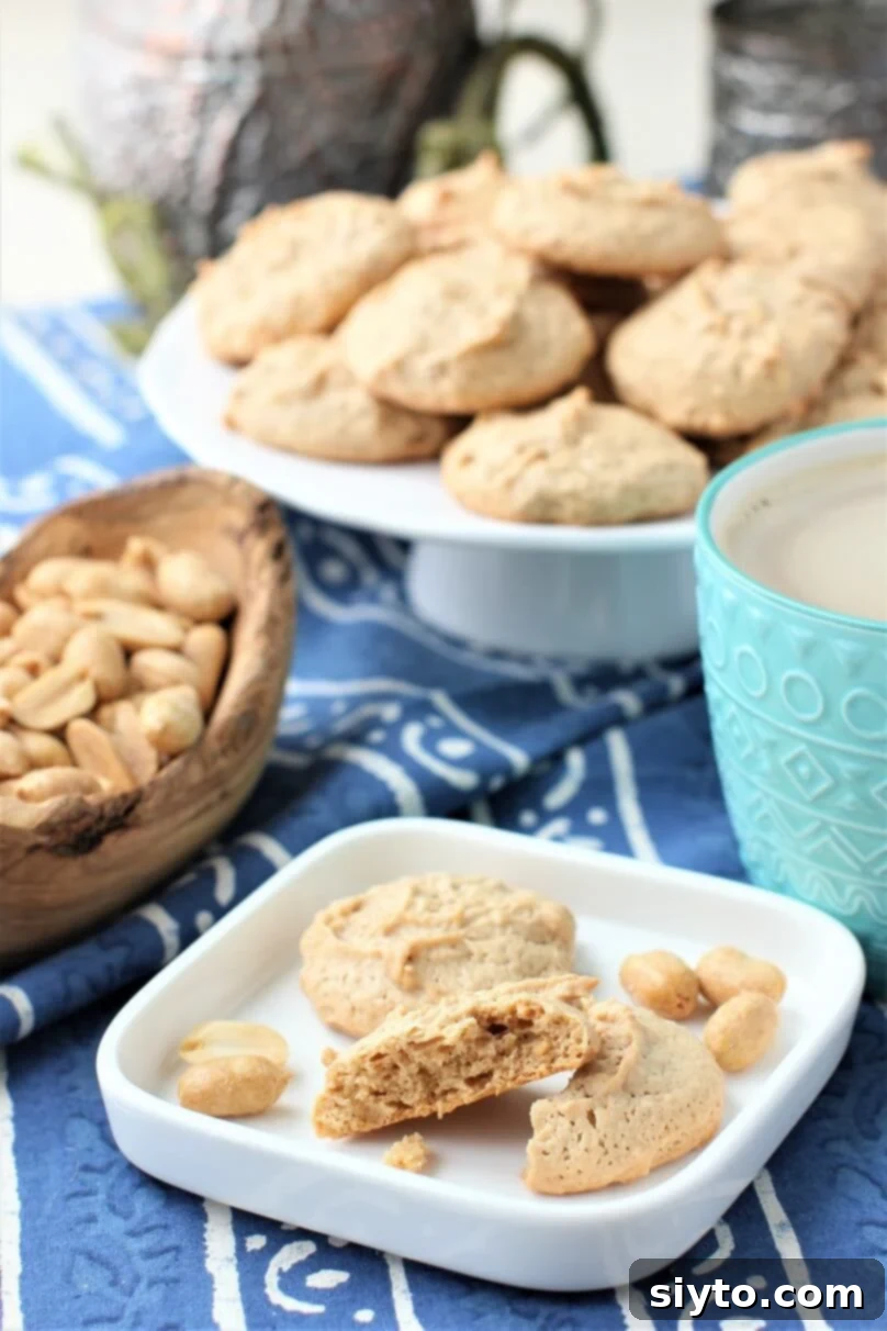 peanut meringues on a plate with mug of coffee, highlighting their delicate form
