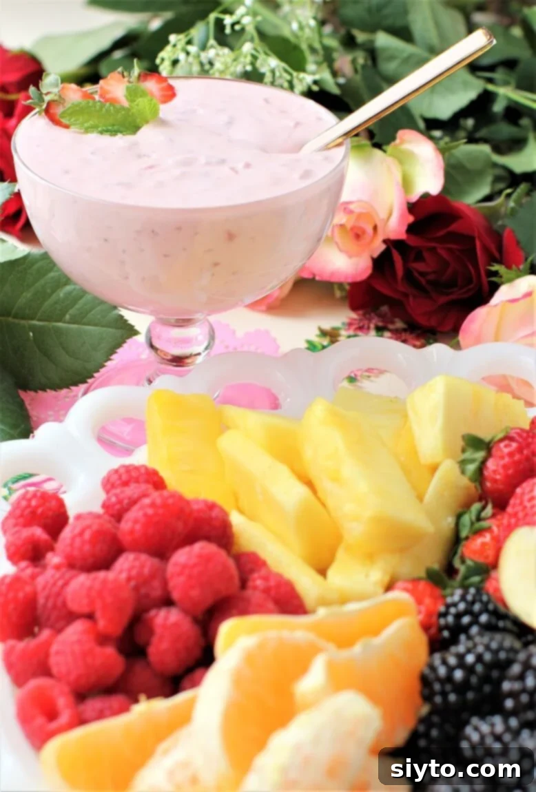 bowl of fruit dip behind a platter of fresh fruit