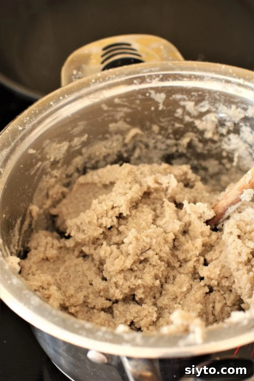 The thick, stiff mass of cooked buckwheat dough, ready to be shaped into Stäerzelen dumplings, showcasing its uniform texture and readiness.
