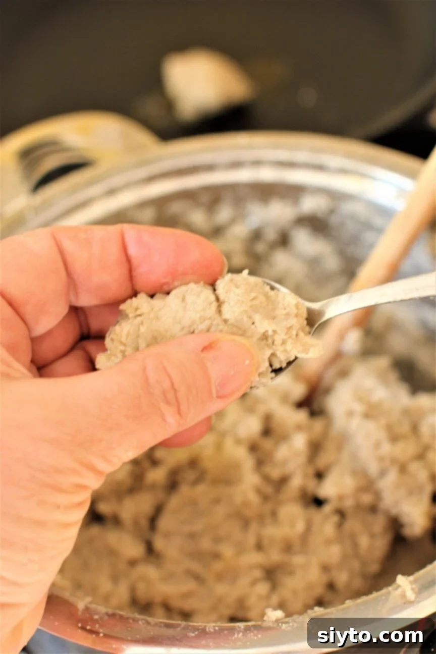 Hands gently shaping the Stäerzelen buckwheat dumplings, emphasizing the rustic and simple forming process.