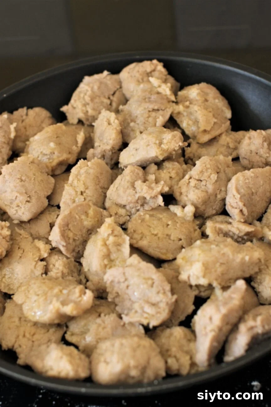 A skillet filled with freshly made Stäerzelen buckwheat dumplings, ready to be served or further cooked.
